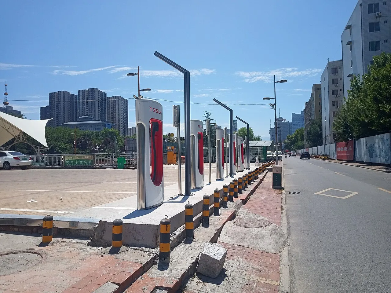 A row of electric vehicle charging posts along a city street